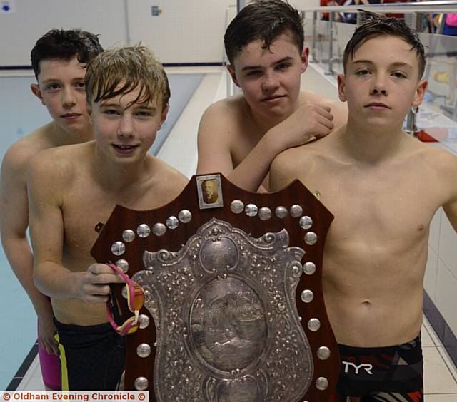 WHAT A SUPER TEAM EFFORT: Brown Shield winners Hulme Grammar are pictured with their big prize. They are (left to right): Jacob Birtles, Tom Sanderson, Tiger Edwards and Tristan Lux
