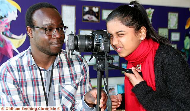 IN focus . . . Photographer Tolu Sholanke with Rumaisa Ahmed (11) photographing the east view of Oldham at the first ever Digital Festival in Oldham Library