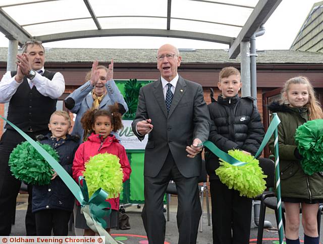 OPEN . . . Sir Bobby Charlton (centre) cuts the ribbon at Woodlands Primary Academy with (from left) acting head teacher Phil Sharrock, Tyler Carnegie, Lady Norma Charlton, India Cudjoe, Brayden Watson and Evaaney Eaves
