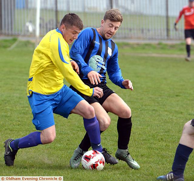 GETTING STUCK IN . . . Royton Athletic's Paul Badby and Horseshoe's Adam Carr.  PICTURES by TIM BRADLEY