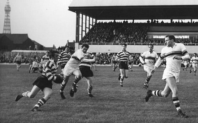 TOWERING PRESENCE . . . Blackpool's Alex Givvons (far right) tracks back to cover Oldham's Joe Collins in season 1964-65
