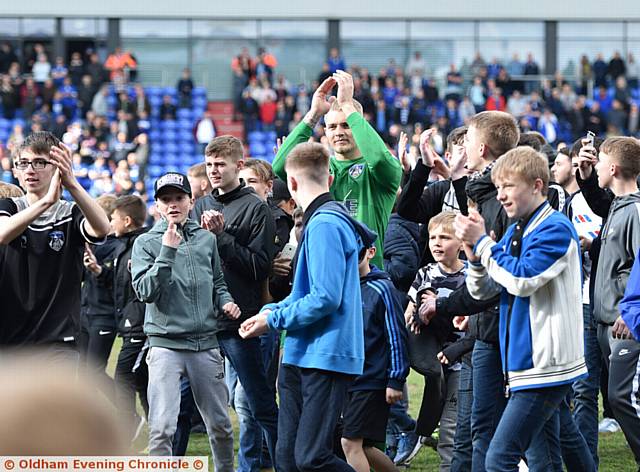 Oldham Athletic 1 Rochdale 1. Connor Ripley mobbed as the fans invade the pitch at full time