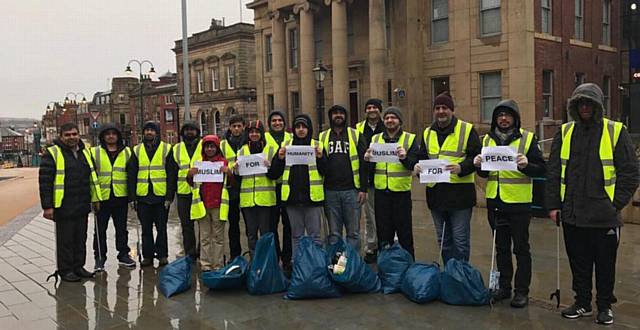 AHMADIYYA Muslims Youth Association members clean up the town centre