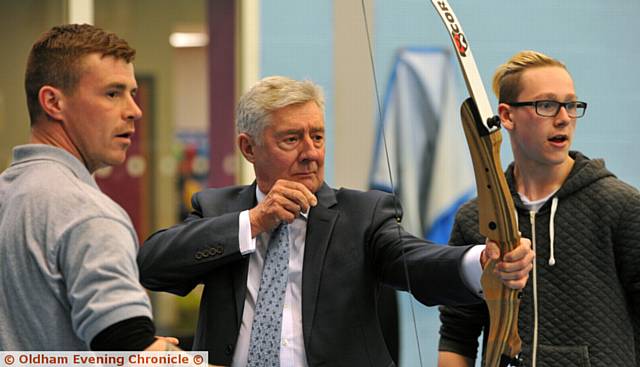 ARCHER . . . Tony Lloyd has a go at archery helped by instructor Mike Hall (left) and Aiden O'Rourke
