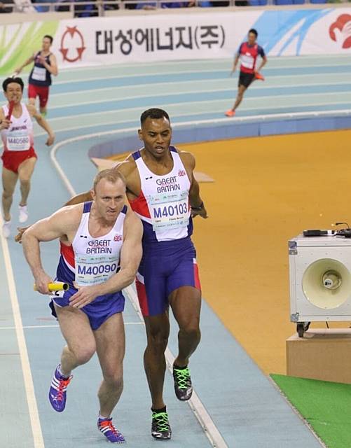 TAKING THE BATON . . . Mike Coogan sets off in the 4x200m sprint relay