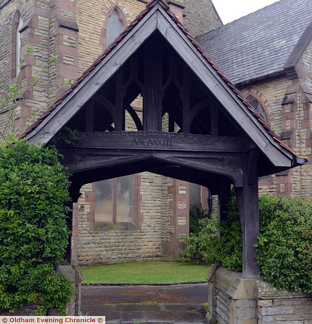 Local historian John Fidler shows the family of former mill owner Alfred Butterworth around local places of interest including Christ Church, Chadderton. Pic shows the lych gate with Alfred's name carved into it.
