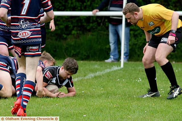 THAT'S A TRY . . . Harry Godfrey touches down for Saddleworth Rangers under the watchful eye of referee Simon Ellis