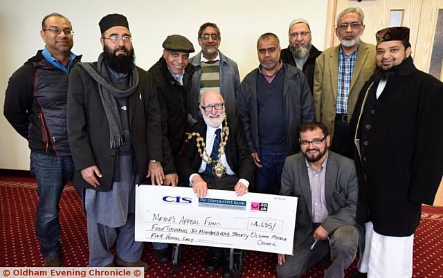 GENEROUS donation . . .

Councillor Derek Heffernan and members of the Mosques Council