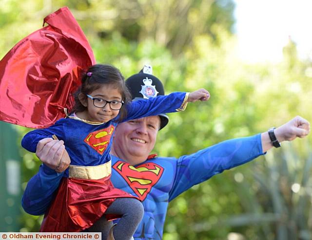 TEAMWORK . . . Young Supergirl Jemimah Samad (5) meets up with Superman Sgt Danny Atherton at Coppice Primary School
