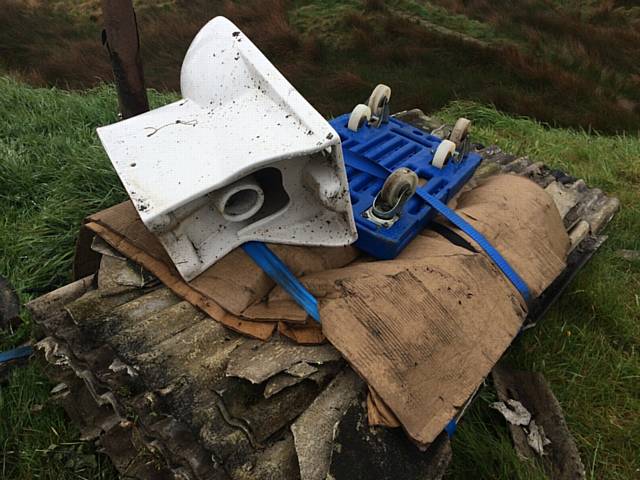 ASBESTOS corrugated roofing tied to a trolley and dumped along with a toilet