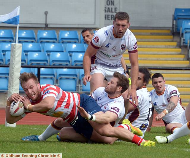 DETERMINATION: Oldham's Adam Clay reaches out to score the second of his hat-trick of tries. 