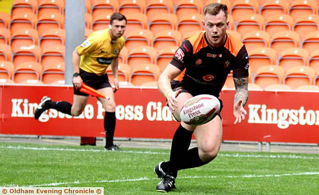 EYES ON THE BALL . . . Scott Turner gathers for Oldham's first try