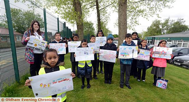 Pupils at Bare Trees Primary School hold posters up outside the school to warn about traffic danger. Pictured in foreground is Tanisha Akhter (5).