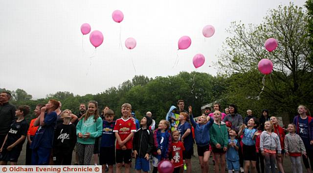 Children take part in a 2K run around Churchill Playing Fields. Before the race set off the runners let go of pink balloons in memory of the victims of the Manchester attack
