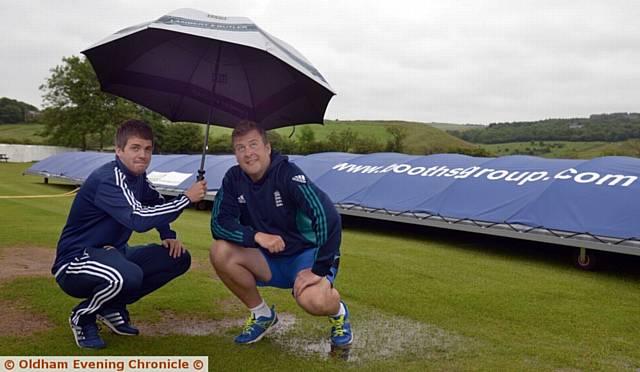 RAIN, RAIN, GO AWAY . . . captains Ryan Barnes (Heyside, left) and Glodwick's Nigel Stock. 
