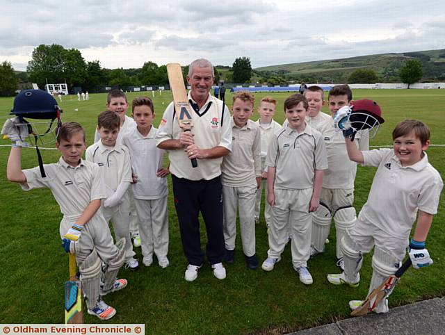 YOUTH AND EXPERIENCE . . . . John Punchard, who will play in this summer's over-60s Ashes series, with his Crompton under-11s team at Glebe Street
