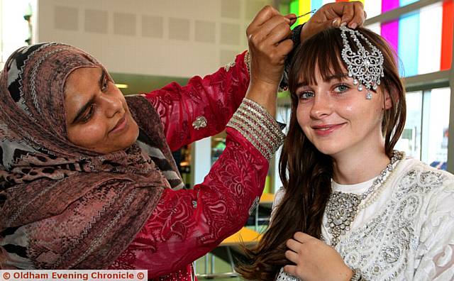 FINISHING touches . . . At Mahdlo Saima Suleman (left), from Culture in a Box, Oldham, helps Lorna Barry dress up in Asian clothing
