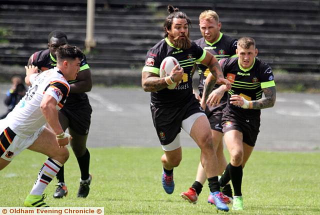 ON THE ATTACK . . . Sammy Gee runs at the Bradford Bulls line as Oldham strive to get back in the game
