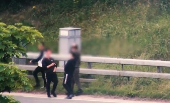 RUSH-HOUR MADNESS Four youths captured on camera running across the M60 between junction 21 Chadderton and junction 22 Oldham on Friday