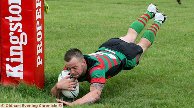 HE'S OVER . . . Waterhead's Carl Sneyd dives over for a try