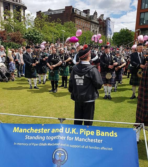 EMOTIONAL . . . Pipe bands play in Piccadilly Gardens to pay tribute to the victims