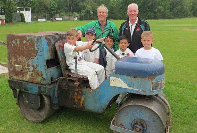 FUND-RAISERS . . . Neil Williams (right) and Gordon Whitehead with a clutch of junior players on the old roller at Glodwick Cricket Club