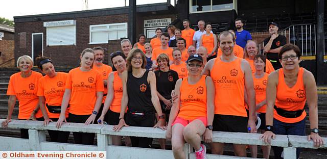 MOSSLEY Running Club member Michelle Phillips sitting on the wall with husband Chris and other members of the club