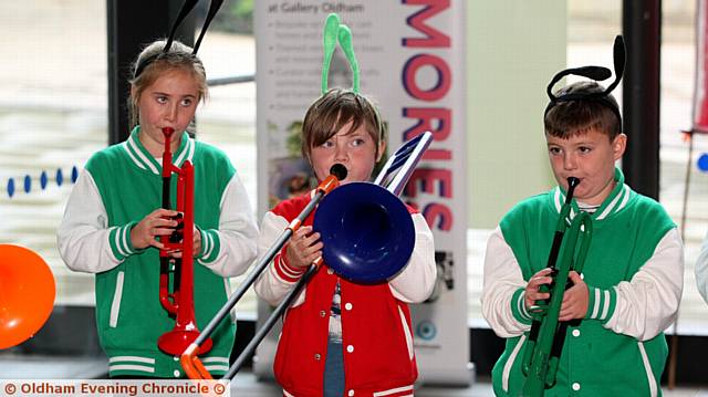 entertainers . . . Phoebe Pritchard (9), Nominee Duncan-Franc (7), Bill Swallow (8) from the Incredible Plastic Street Band performing at Galley Oldham

