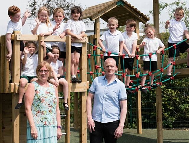 FIR Bank Primary School head teacher Hazel MacKay and Tom Biggs, from Creative Play, pictured with children from the school council who helped design the new play area