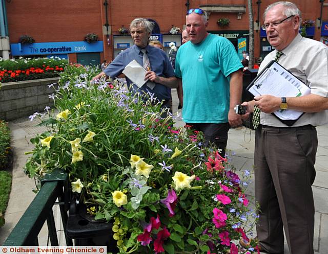 DISPLAY . . . Oldham gardening team leader Lee Gannon (centre) with the judges