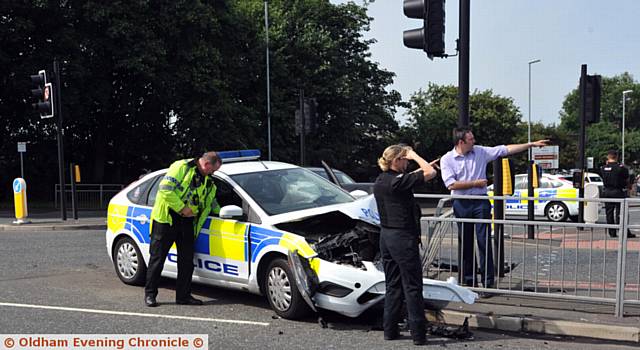 CRUNCH . . . the damaged police car embedded in railings at the junction of Lees Road and Cross Street