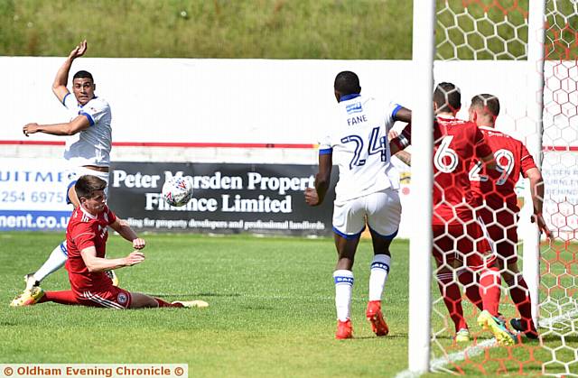 SHOOT ON SIGHT . . . Courtney Duffus' strike on goal is handled on the goal-line for an Athletic penalty