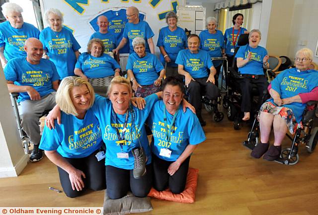 Staff at Housing and Care 21 home Trinity House who will be climbing Mount Snowdon, and residents wearing matching t-shirts to show their support. Climbers are pictured in foreground left to right, Joanne McWhirter, Tracy Ewins (assistant court manager), Adele Farrow