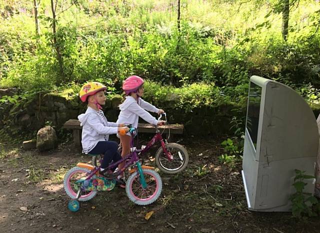 Macy Hilton and her sister Harley get a bike-side view of the dumped TV in this picture taken by their mum Claire
