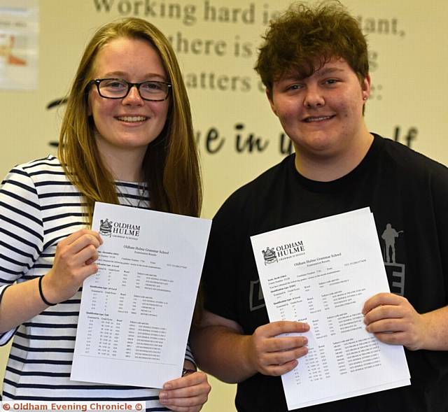 DELIGHT . . . Hulme Grammar School students Alexandra Sledge (3A* and 1A) and Jake Scott (3A* and 2A)