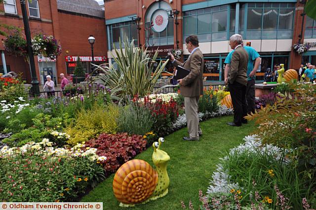 Britain in Bloom judging in and around Oldham. Pic shows judges at the town centre display.