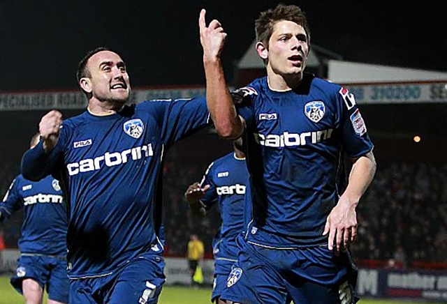 James Tarkowski (right) celebrates a 2013 goal during his time with Athletic