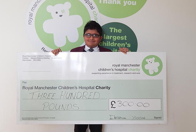Ibrahim Yousaf at the Royal Manchester Children's Hospital with his donation cheque
