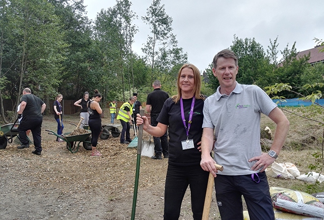 First Choice Homes' Volunteer Co-Ordinator Naomi Martin-Smith and company CEO Vinny Roche take a break from helping out at Give and Gain Day on Holts Estate