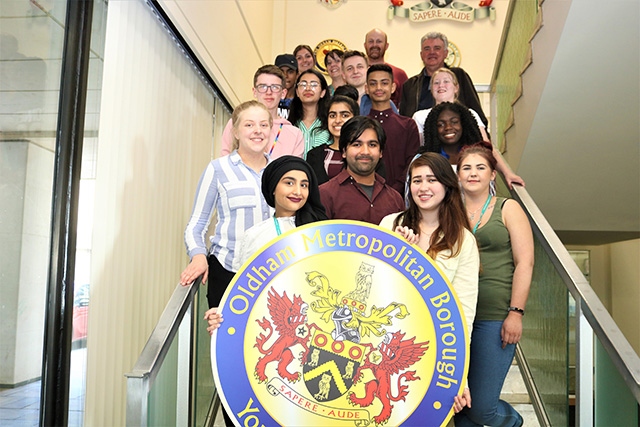 Pictured are members of Oldham Youth Council (front), Oldham Council Youth Service workers (back) and Stephen Lowe, Deputy Lieutenant of Greater Manchester (back, right).