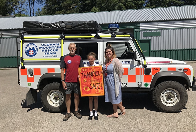 A member of the Oldham Mountain Rescue Team is pictured with Knowsley Junior School pupil Maisie Comer and Jade Phillips (Year 5 teacher)
