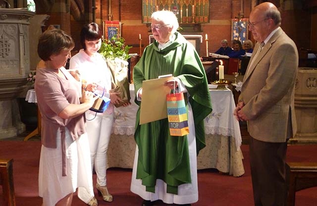 Church wardens Christine Longhurst (left) and Janice Perkins present the Rev Michael Howarth with retirement gifts from the congregation, accompanied by Peter Shrigley, a church officer.