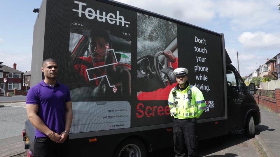 Calvin Buckley (left) and Inspector Jamie Buchanan in front of a campaign ad-van which could be seen driving across Greater Manchester today (Tuesday) to help spread awareness of Touch. Screen