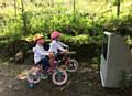 Macy Hilton and her sister Harley get a bike-side view of the dumped TV in this picture taken by their mum Claire