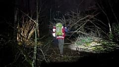 An Oldham Mountain Rescue Team member assists at the Tameside incident during the night