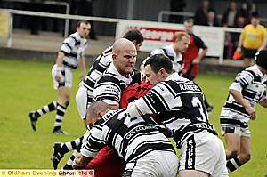 SADDLEWORTH gang up to stop St Maries’ Michael Foster.