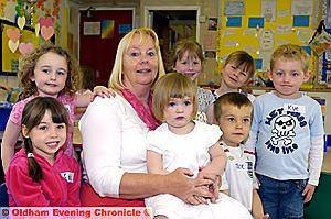 ANGELA KIRKHAM surrounded by some of the children who attend the nursery. Back row, from the left: Katie O’Brien, Bobbie Carey, Mia Ratcliffe, Hannah Penny, Kye Farrugia. Front: Erin Healer, Annabel Swindells and Jack Canny