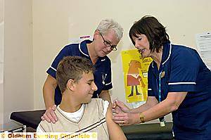 This won’t hurt. . . Gill Preston (back left) and Mal Colier with patient Samuel Preston This won’t hurt. . . Gill Preston (back left) and Mal Colier with patient Samuel Preston