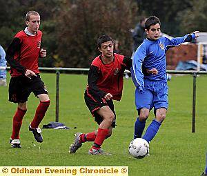 SCOTT Dawson, of Oldham Schools (right), gets a nudge in the side. 