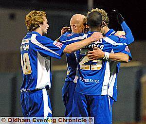 Hughes and teammates celebrate his first of two strikes. 